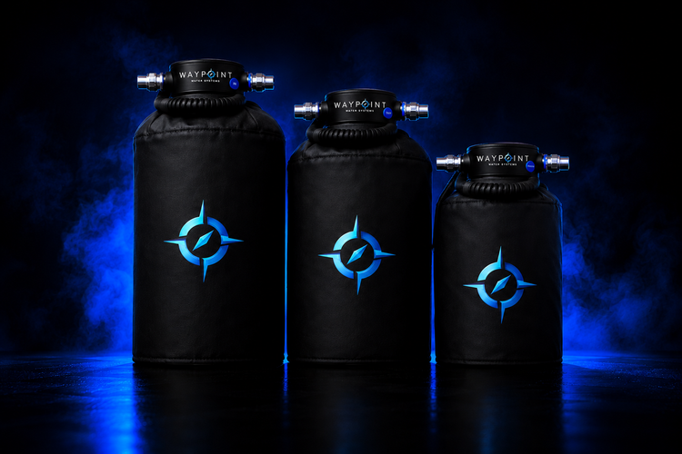 Waypoint portable marine water softener lineup featuring three premium black soft water systems with blue compass logos, photographed in a dark luxury studio with dramatic blue lighting and reflective surface.